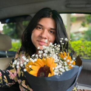 Professional South Asian female english Language, AutoCAD, SketchUp teacher wearing a hijab, smiling confidently in front of plants — expert online tutor at MyUstaza.