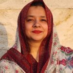 Expert Urdu Language Tutor – MyUstaza Online Learning Platform Professional South Asian female Urdu teacher wearing a hijab, smiling confidently in front of plants — expert online tutor at MyUstaza.