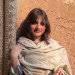 Expert Photoshop Language Tutor – MyUstaza Online Learning Platform Professional South Asian female Photoshop teacher smiling confidently in front of plants — expert online tutor at MyUstaza.