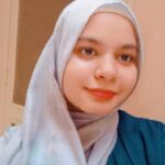 Expert Home work assistance, History and story telling teache Tutor – MyUstaza Online Learning Platform Professional South Asian female Home work assistance, History and storry telling teacher wearing a hijab, smiling confidently in front of plants — expert online tutor at MyUstaza.