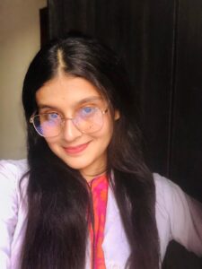 Expert Biology tutor – MyUstaza Online Learning Platform Professional South Asian female Biology teacher smiling confidently in front of plants — expert online tutor at MyUstaza.